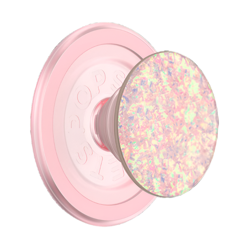 This image shows a close-up of a pink MagSafe-compatible PopSocket with an iridescent, glittery top. The PopSocket features a circular magnetic base for attachment to MagSafe devices and a collapsible grip with a shimmering, multicolored design that reflects light beautifully. This accessory combines both functionality and aesthetic appeal, offering a secure phone grip with a stylish finish.