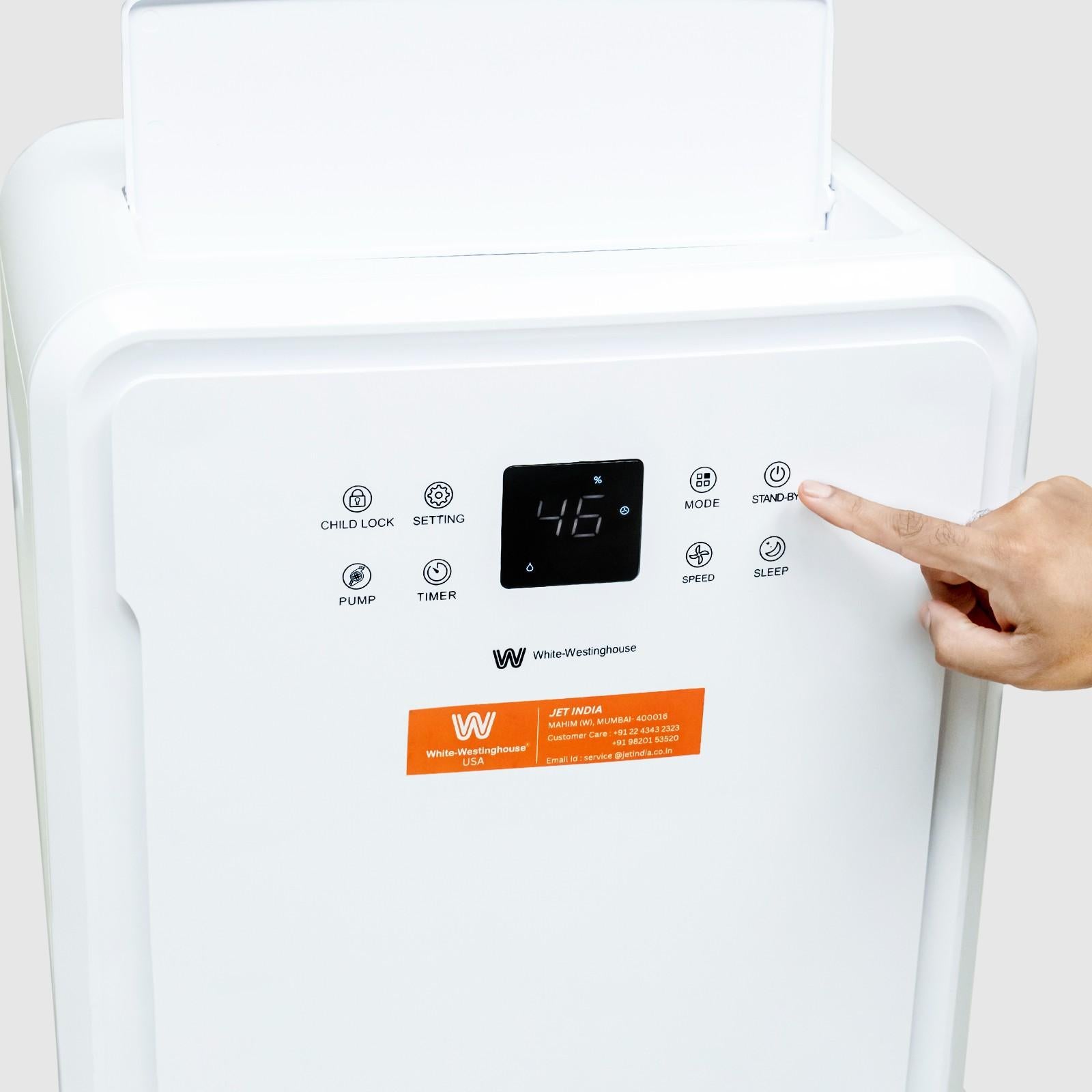 Close-up view of a person pressing the mode button on the digital control panel of the White Westinghouse Dehumidifier WDE702. The sleek white design features intuitive buttons and a display, suitable for maintaining optimal humidity levels in residential and commercial spaces.