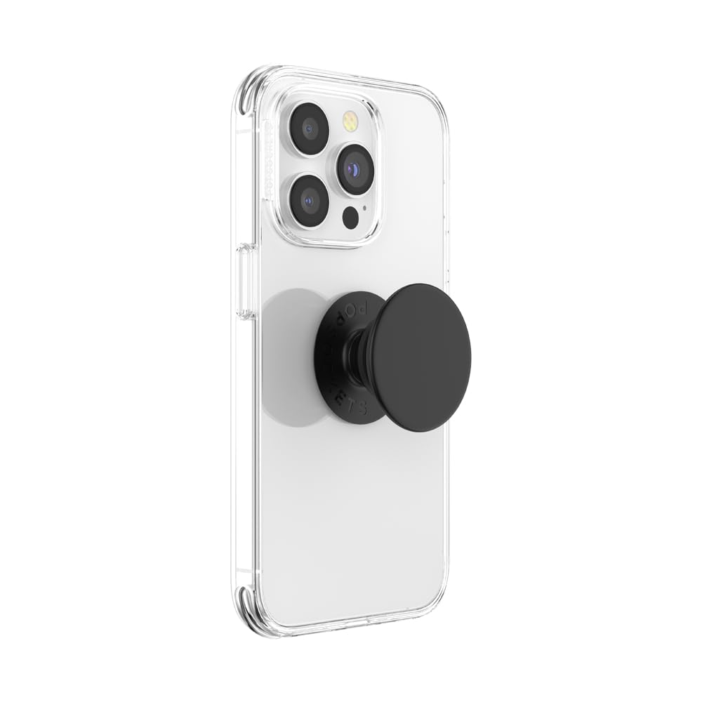 A white smartphone with a clear case, featuring a black PopSockets Phone Grip with Expanding Kickstand attached to the back. The grip is in its collapsed state, providing a sleek and minimalist look. The clear case allows the phone's design to be visible while the black PopSocket adds functionality and style, making it easier to hold the phone securely and use the kickstand feature for hands-free viewing.