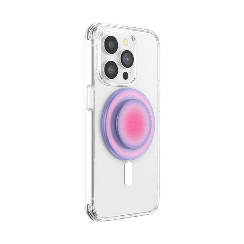  A smartphone with a clear case is shown with an Aura PopGrip for MagSafe attached to its back. The PopGrip features a round, flat surface with a gradient color pattern transitioning from pink in the center to purple on the edges, positioned centrally on the phone's back. The phone's camera lenses are visible at the top, highlighting the PopGrip's stylish and colorful design, which complements the phone's aesthetics while providing a functional grip.