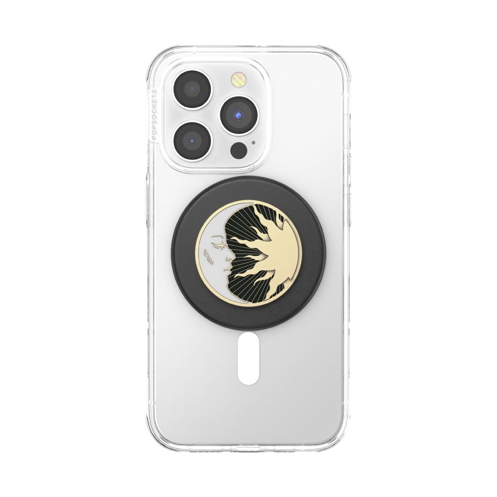 The image features a **PopSocket** with a **celestial sun and moon design** in black and gold, attached to a **clear phone case** on an iPhone. The PopSocket's circular top showcases the intricate sunburst rays meeting the moon’s face, with a stylish black base that complements the design. The setup enhances the phone’s usability for gripping and holding, while adding an elegant, artistic touch.