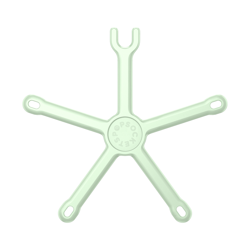  PopSockets Flex Mount in Honey Dew color laid flat, showing its flexible, starfish-like design. The mount has a circular center with five adjustable legs extending outward, each with a loop at the end. The upper section designed to hold a smartphone is also visible, positioned in the center. The mount is colored in a light mint-green shade, displaying its versatile and bendable structure.