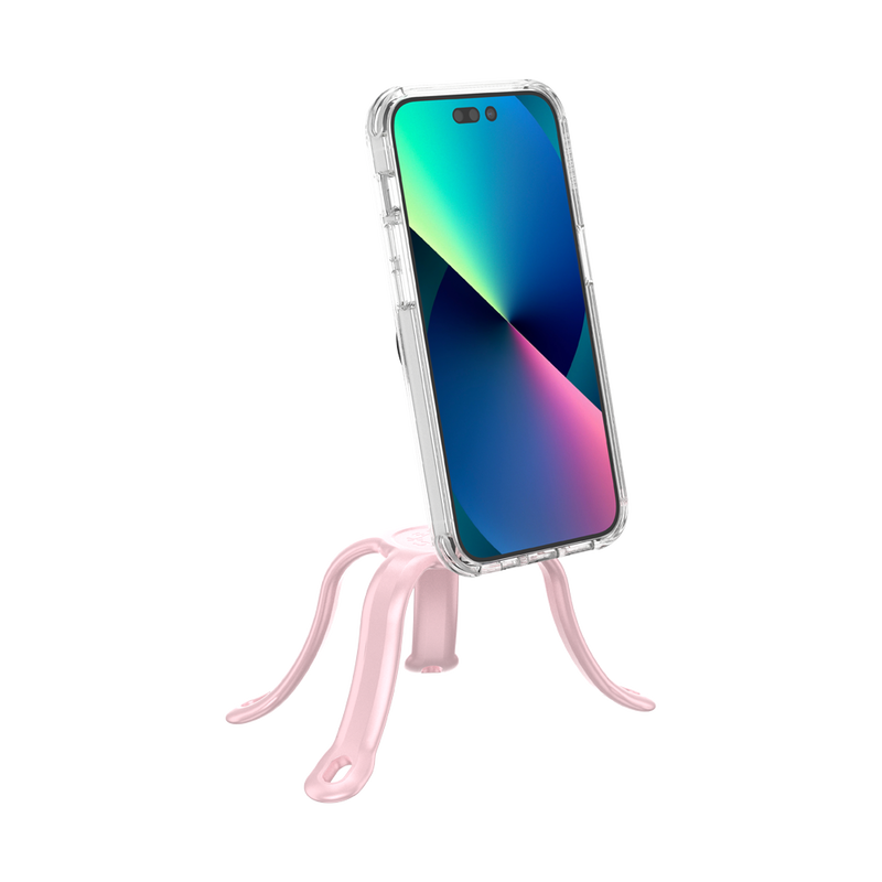 PopSockets Flex Mount in Pinky color holding a smartphone with a colorful screen in a clear case. The mount's flexible legs are positioned to support the phone upright on a flat surface. The phone is shown from the front, highlighting the screen and the light pink colored flexible mount's design.