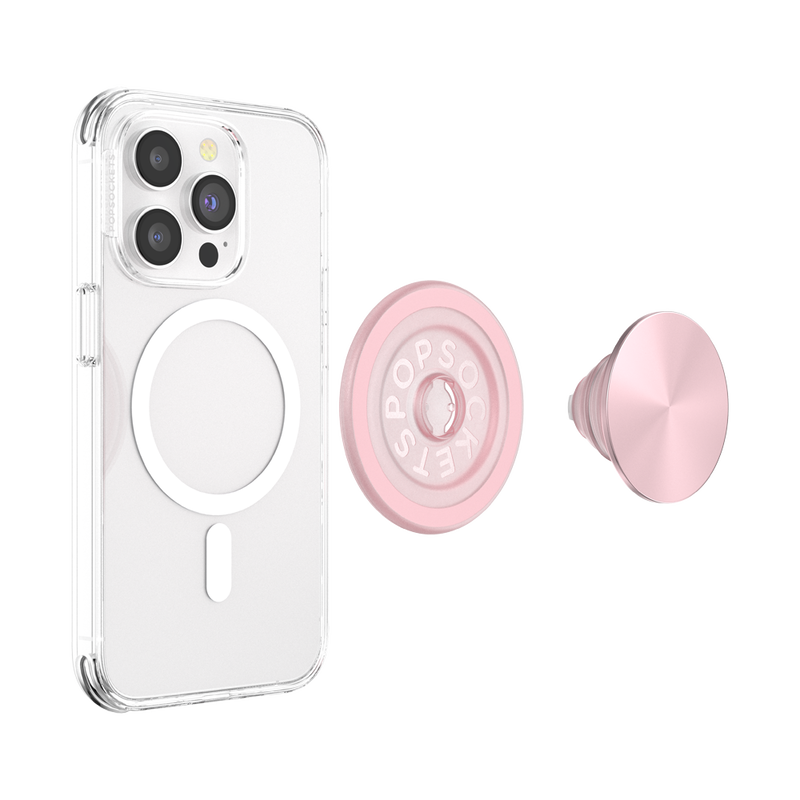 A smartphone with a clear case is shown next to a disassembled PopSockets MagSafe PopGrip in dusty rose color. The phone's back displays the MagSafe alignment ring, indicating its compatibility with MagSafe accessories. The PopGrip is separated into two parts: the round base with the PopSockets logo and the extendable grip with a glossy soft pink surface. The clear case allows visibility of the phone's details and the MagSafe ring, highlighting the PopGrip's stylish and functional design.