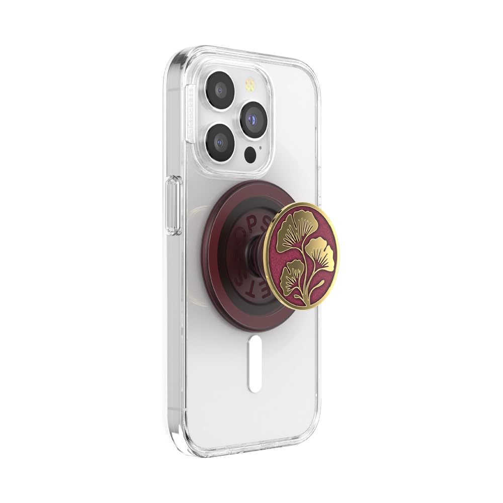 This image features a **clear phone case** with a **golden ginkgo leaf PopSocket** mounted on a **deep maroon magnetic base**. The PopSocket extends outward, serving as a **stylish grip or stand** for the phone. The elegant gold-on-maroon design highlights a sophisticated and luxurious look, while the clear case complements the phone's design.