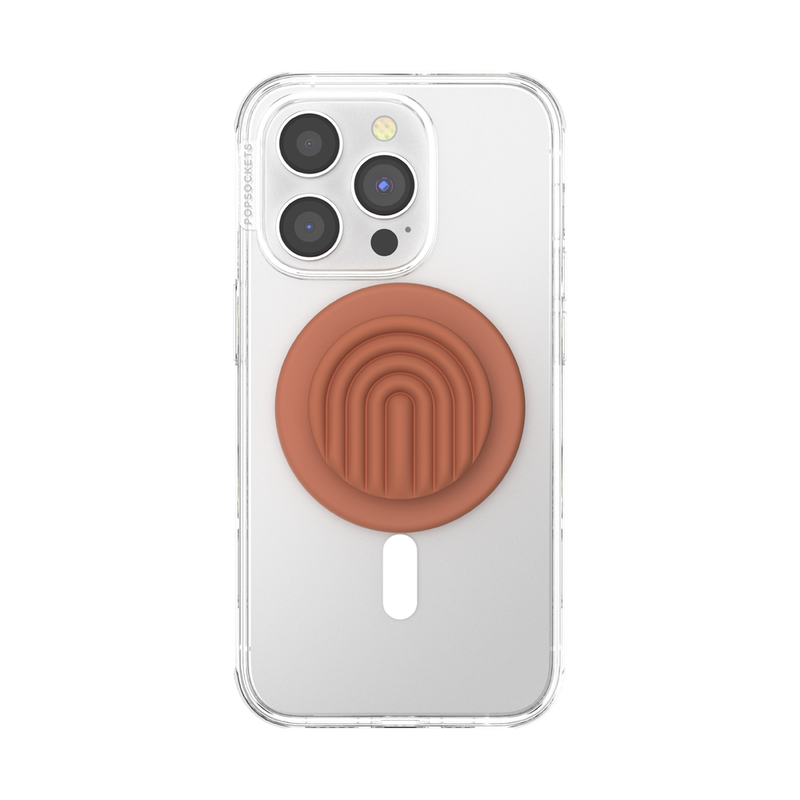 A clear phone case is shown attached to a smartphone with a PopOut Terracotta Curves PopGrip for MagSafe. The PopGrip, featuring a terracotta-colored design with curved lines, is centered on the back of the phone case, providing a secure and stylish hold for the devic