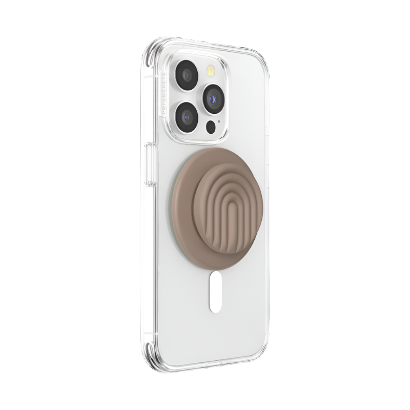  A clear phone case is shown attached to a smartphone with a PopOut Latte Curves PopGrip for MagSafe. The PopGrip, featuring a latte-colored design with curved lines, is retracted, providing a compact and stylish hold for the device