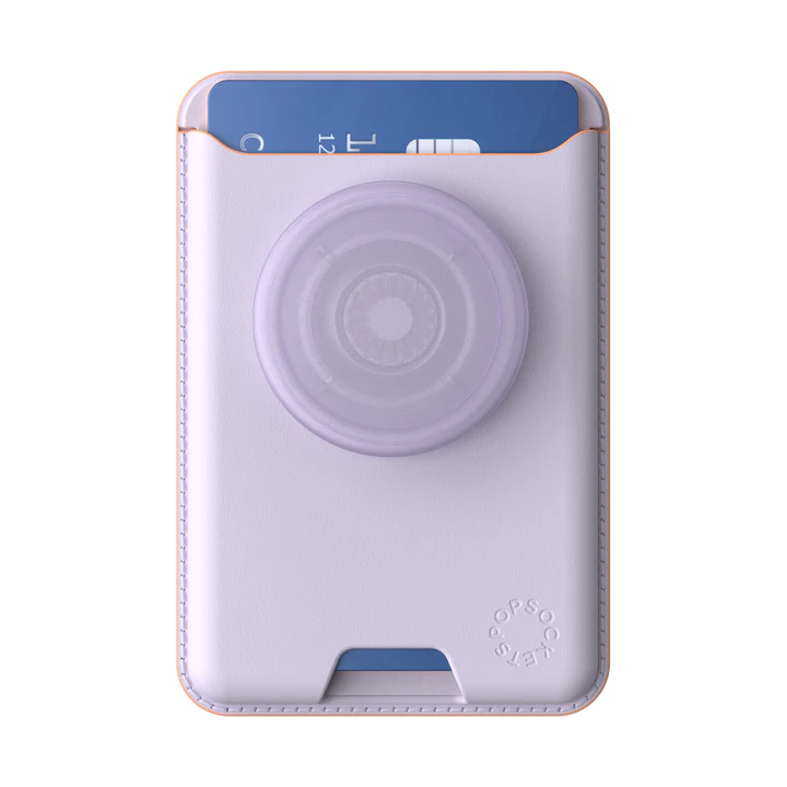 A PopSockets MagSafe Softgoods PopWallet in Pale Lavender color shown from the front. The wallet has a credit card partially inserted in the top slot. The attached PopSocket, also in pale lavender, is prominently displayed in the center. The PopWallet features neat stitching along the edges and the "PopSockets" logo embossed near the bottom corner. The wallet's soft material and sleek design are highlighted, with the pale lavender color giving it a stylish and modern look.