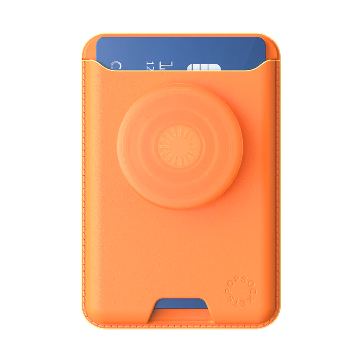 A Softgoods PopWallet for MagSafe in a bright cantaloupe color, holding a blue card in its pocket. The wallet has a circular PopGrip in the same cantaloupe color on its front, providing both a secure grip and additional functionality. The wallet design is minimalistic and practical, featuring a slot for easy access to the card.