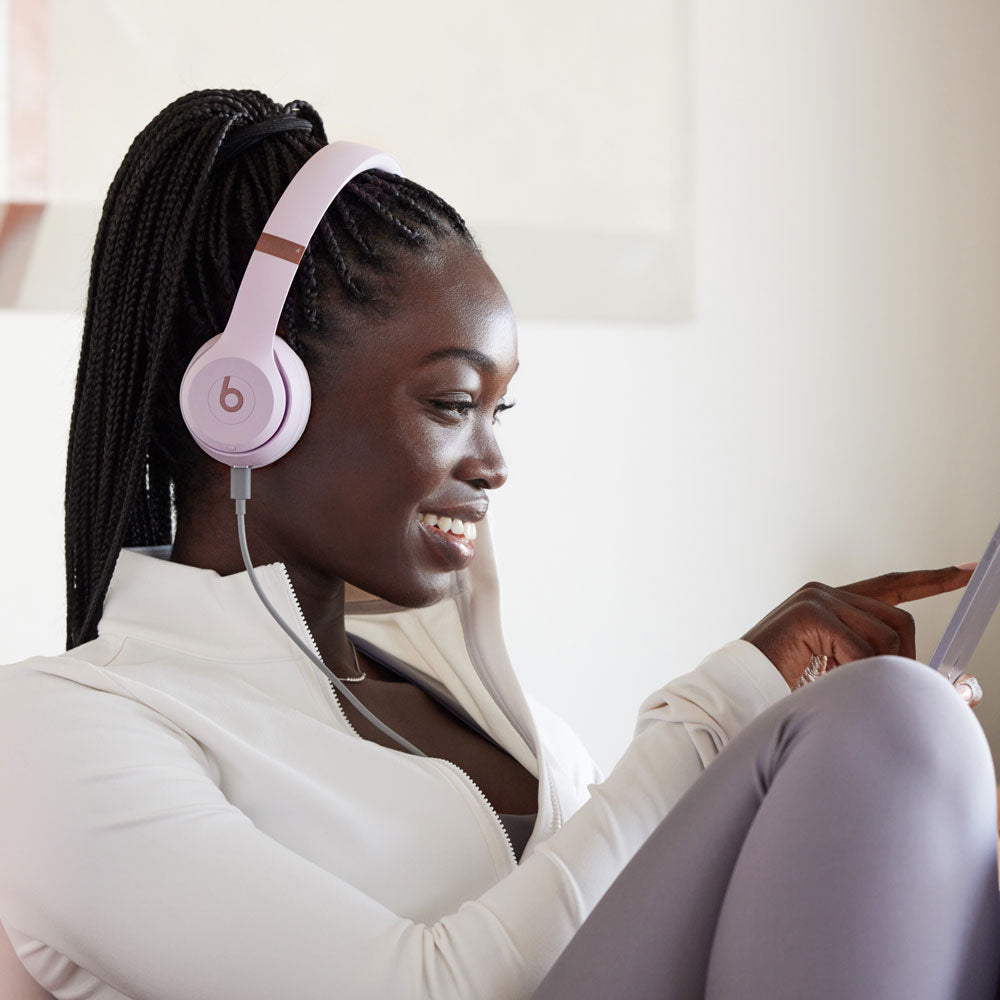 "Beats by Dre over-ear headphones in pastel purple being worn during a relaxed moment, highlighting comfort and stylish design."