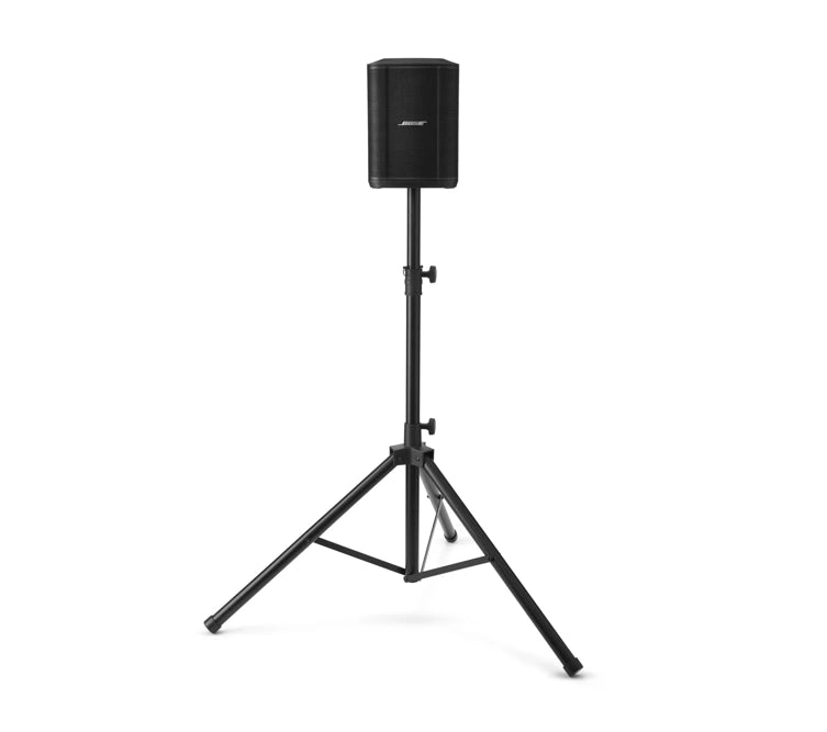 A black Bose speaker mounted on a tripod stand. The tripod has three adjustable legs and a central pole with a height adjustment mechanism to securely hold the speaker at the desired height. The setup is designed for stable and elevated sound projection in various environments.