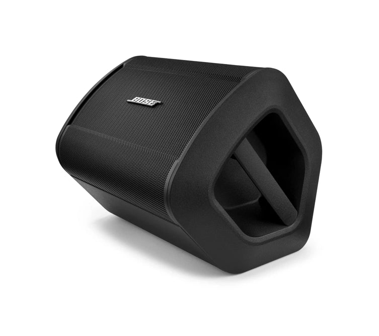 Side view of a black Bose speaker lying on its side. The speaker has a built-in handle for easy portability and a sleek, curved design with the Bose logo prominently displayed on the front grille. The overall design is modern and functional, emphasizing portability and ease of use.