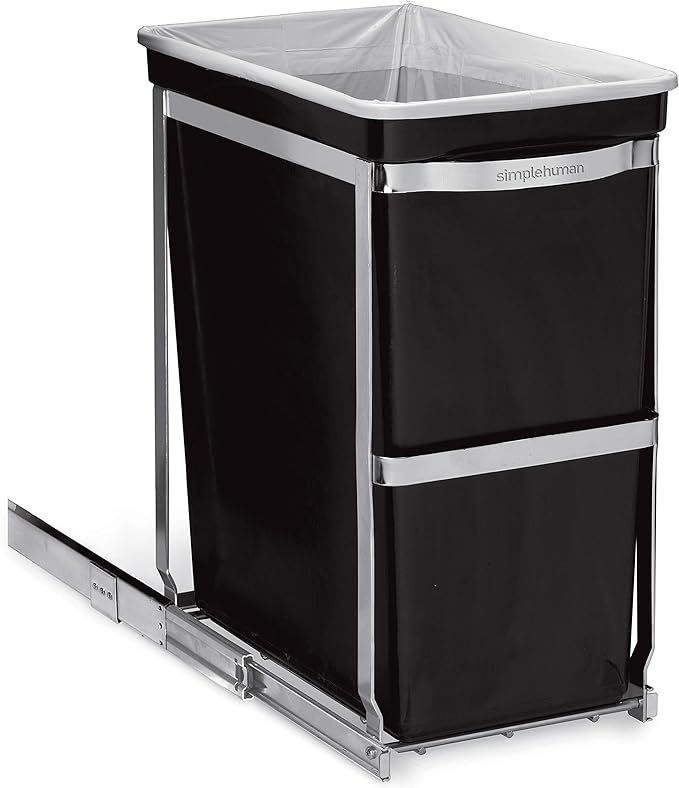 This image displays a Simplehuman pull-out trash bin featuring a polished metal frame and a robust sliding mechanism. The black bin is neatly fitted within the metal structure, which ensures a smooth and secure pull-out action, suitable for placement inside cabinets. The design includes a bag liner rim that keeps the trash bag in place and concealed, providing a clean and tidy appearance. This practical and stylish solution is perfect for maintaining an organized and efficient kitchen or utility space.