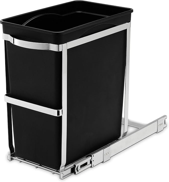 This image shows a sleek, modern pull-out trash bin designed for built-in cabinet use. The black bin is held securely within a polished metal frame with a sliding mechanism that allows for smooth and easy movement in and out of the cabinet space. The design ensures the trash bin is easily accessible while remaining hidden when not in use, perfect for maintaining a clean and organized kitchen environment. The polished chrome accents give a refined touch, making it both functional and aesthetically pleasing.