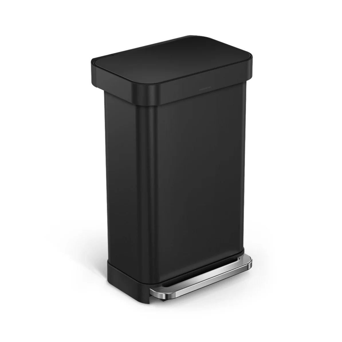 The image shows a black Simplehuman trash can with a rectangular shape and rounded corners, viewed from an angled perspective. The can features a matte black finish and a stainless steel foot pedal at the base, designed for hands-free operation. The sleek, modern design is typical of Simplehuman products, offering both functionality and style. The can's clean lines and minimalist aesthetic make it a practical and attractive choice for contemporary kitchens, bathrooms, or office spaces. The overall design em