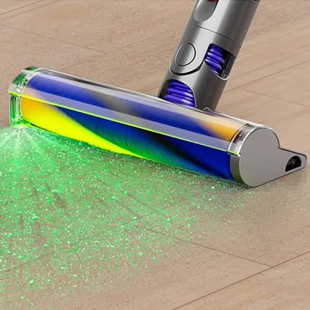 Cordless vacuum cleaner with laser detection technology, highlighting hidden dust and debris on hardwood floors for thorough cleaning.