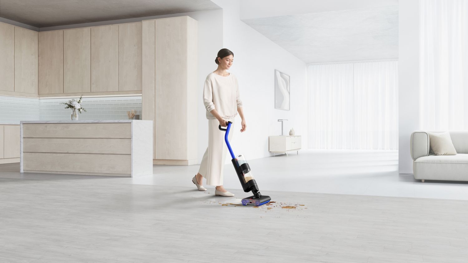 Cordless vacuum cleaner in use on a large, bright living room floor, effectively cleaning up debris with a sleek design, while a person in a neutral outfit operates it effortlessly.