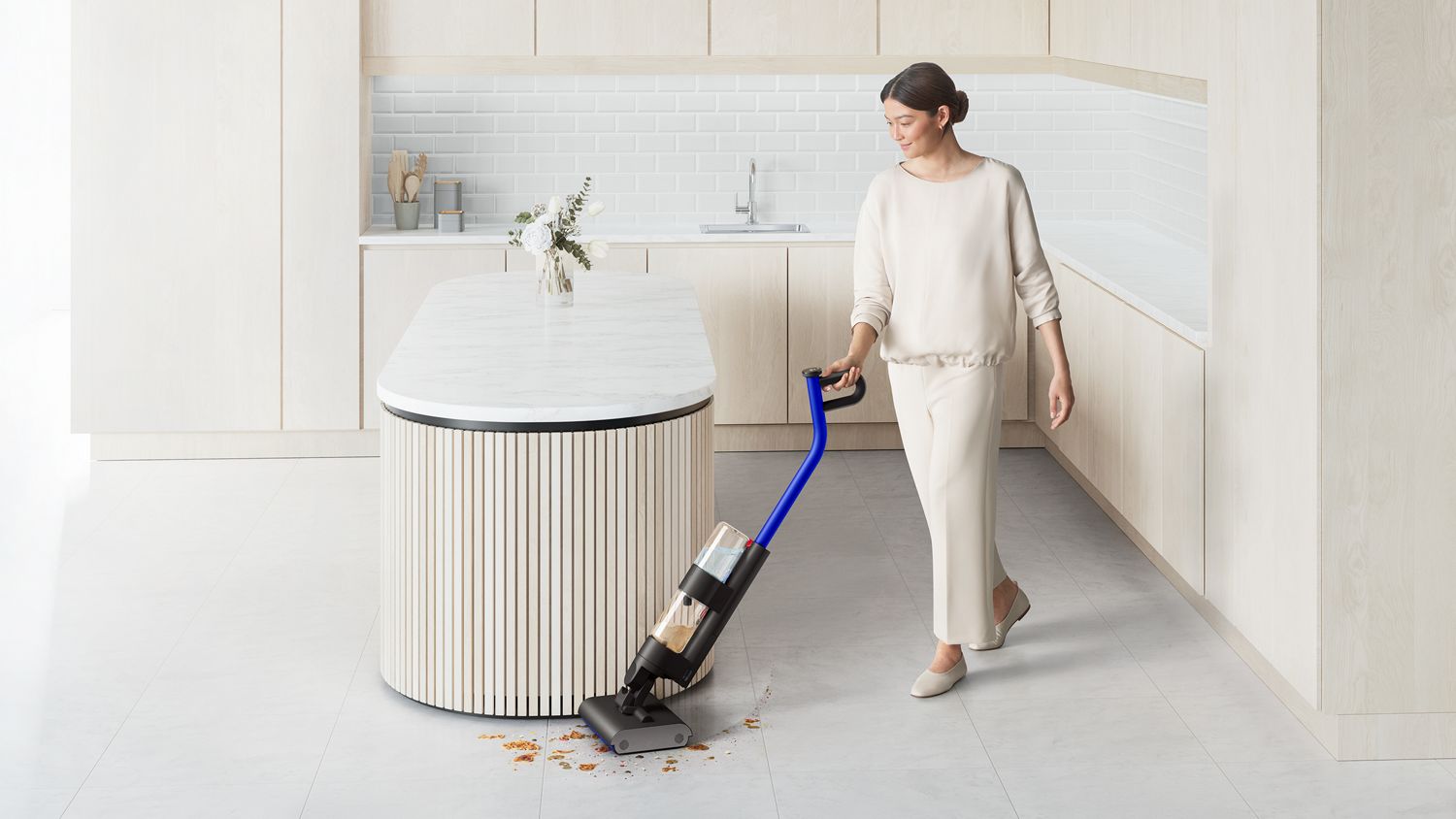 Cordless vacuum cleaner in a modern kitchen, efficiently cleaning crumbs and debris around an island counter with ease.