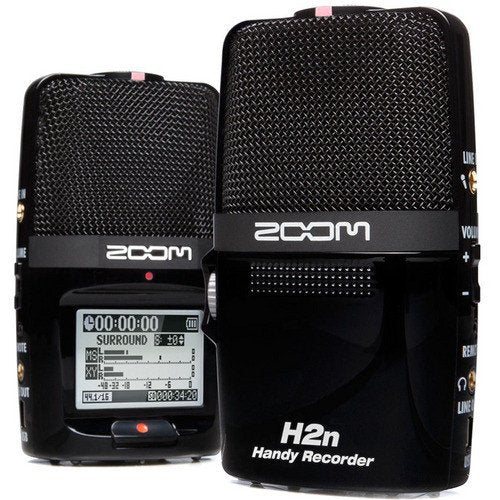 Two Zoom H2n Handy Recorders displayed side by side. The recorder on the left shows the front microphone grille and large LCD screen displaying recording information and audio levels, with the recording mode set to SURROUND. 