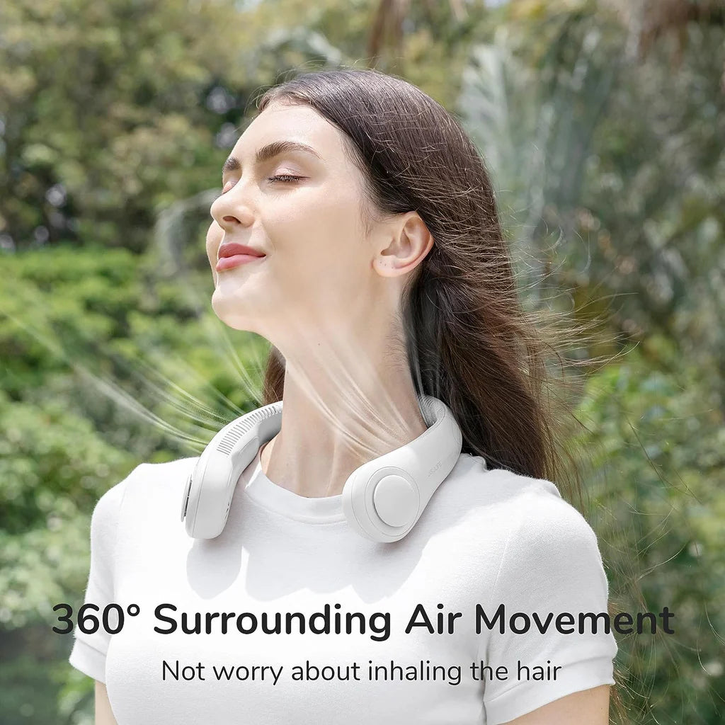 A woman enjoying the refreshing airflow from a white JisuLife wearable neck fan, featuring 360-degree surrounding air movement for efficient cooling, designed for comfort and safety without risk of inhaling hair.