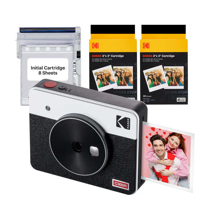 A Kodak C300R instant camera bundle in a black-and-white design includes the camera, an initial cartridge with 8 sheets, and two additional 30-sheet cartridges for instant photo printing.