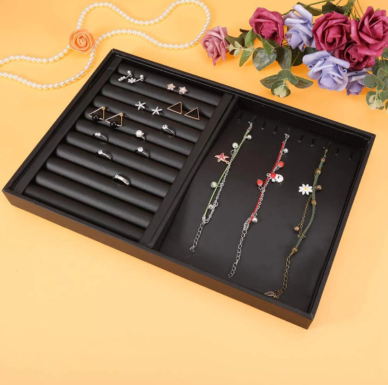 Jewelry organizer tray with sections for rings, earrings, and hanging bracelets or necklaces.