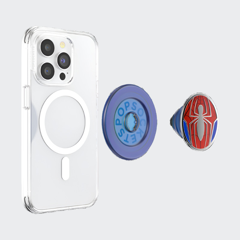  A clear smartphone case with a circular MagSafe ring visible on its back, shown alongside a detachable PopSocket phone grip. The PopSocket features a blue base with the word "POPSOCKETS" embossed on it and a top surface with a Spider-Man inspired design, including a red and blue spider web pattern and a stylized silver spider emblem in the center. The PopSocket is shown in a separated, expanded state, highlighting its detachable nature.