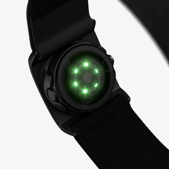 A close-up view of a Polar optical heart rate sensor with a black adjustable strap. The sensor's green optical heart rate monitoring lights are illuminated, highlighting its functionality. The strap is designed for a secure fit around the chest, with an adjustable buckle for customization. The sensor's detailed components are visible, showcasing its advanced technology.