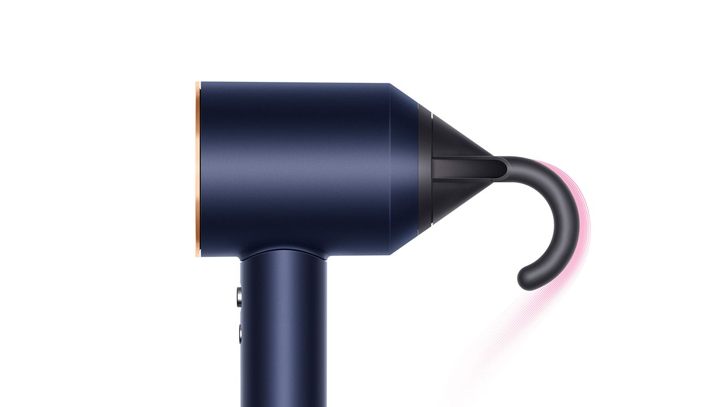 This image displays a side view of a navy and gold hairdryer equipped with a sleek attachment at the nozzle. The attachment appears to channel airflow in a unique way, likely designed to create specific styling effects or improve the precision of air delivery. The overall design maintains a minimalist and elegant aesthetic.