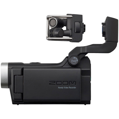 Side view of the Zoom Q8 Handy Video Recorder with the microphone detached, showcasing the detachable top-mounted microphone, LCD screen, and compact design.