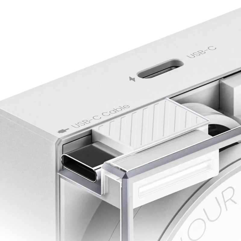 Close-up view of the Sharge transparent power adapter in white, highlighting its built-in USB-C port and integrated USB-C cable storage. The sleek design combines functionality with a modern aesthetic.