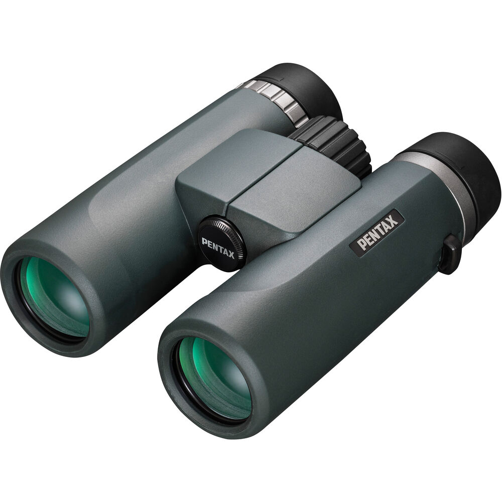 A pair of Ricoh Pentax AD 10x36 WP binoculars with a sleek, ergonomic design. The binoculars feature large objective lenses with a greenish tint and a durable body with a matte green finish. The Pentax branding is prominently displayed on the side of the right barrel. The central focusing wheel is positioned between the two barrels for easy adjustment. The binoculars are designed for a comfortable grip and handling, emphasizing high-quality optics and durability.