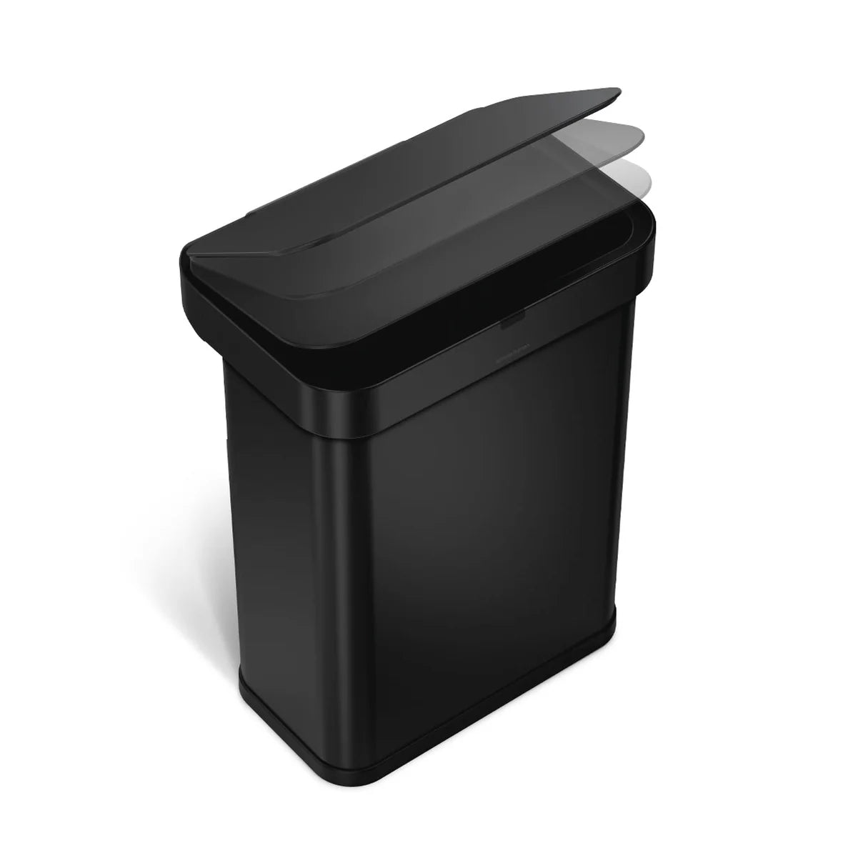 The image shows a Simplehuman trash can with a matte black finish, viewed from an angled top-down perspective. The trash can features a rectangular shape with rounded corners, and the lid is shown in motion, highlighting its ability to open smoothly. The matte black finish gives the trash can a sleek, modern look, making it an ideal choice for contemporary spaces. The lid's motion in the image suggests it might be sensor-activated or designed for easy, hands-free operation, further emphasizing the can's fun