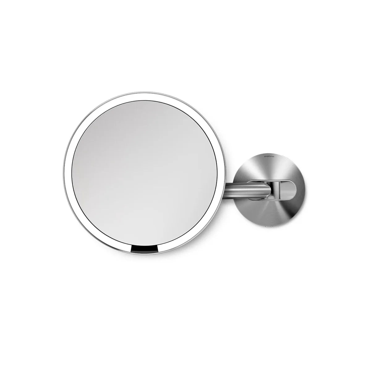 The image displays a round wall-mounted mirror with a polished silver frame. The mirror is attached to an adjustable silver arm and mount, showcasing a sleek and modern design. The mirror's minimalist appearance, combined with its functional adjustable arm, makes it a perfect addition to any bathroom or vanity space. Its elegant silver finish adds a touch of sophistication, making it ideal for tasks such as grooming or makeup application.