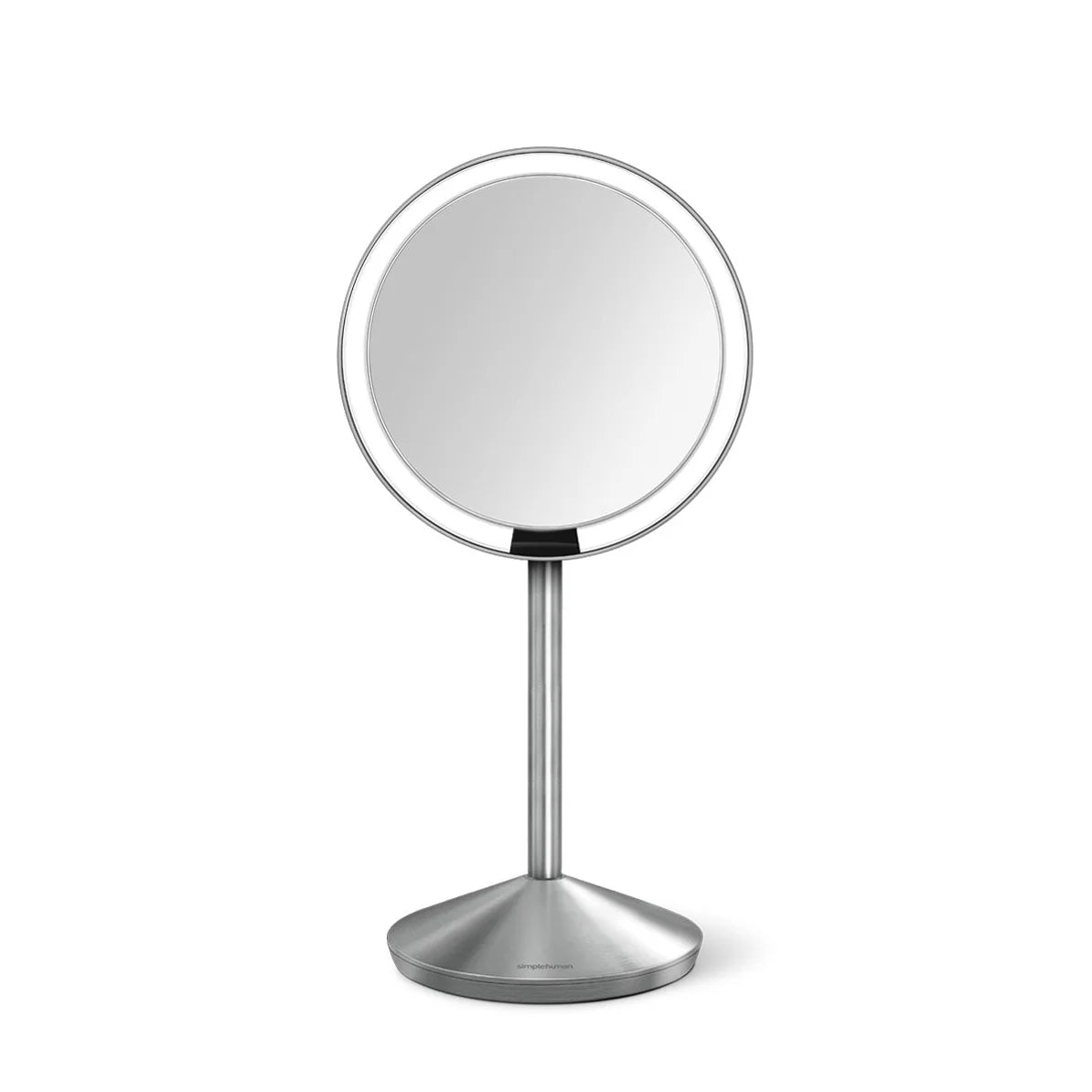  A front-facing view of a sleek, circular vanity mirror mounted on a slim, brushed stainless steel stand. The mirror has a thin bezel, offering a large reflective surface with a modern and minimalist appearance. The base is sturdy and weighted, with a matching brushed metal finish, ensuring stability. The design is contemporary and elegant, ideal for use in a modern vanity or bathroom setting.