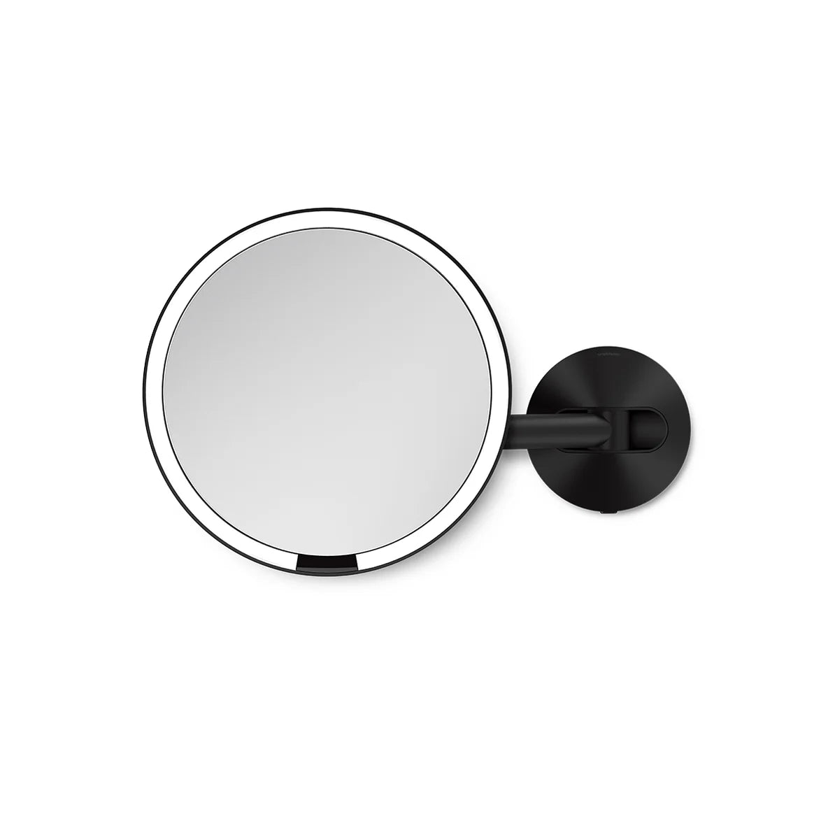 The image shows a round wall-mounted mirror with a sleek, modern design. The mirror is framed with a thin, polished rim and is attached to a black, adjustable arm and mount. The minimalist design and clean lines make it a stylish addition to any bathroom or vanity area, offering both functionality and aesthetic appeal. The adjustable arm allows for easy positioning, making it ideal for tasks like makeup application or grooming.