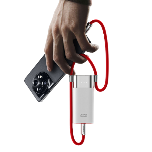 The image you uploaded depicts a hand holding a smartphone, with a white and metallic cylindrical device connected to the phone via a red cable. The device appears to be a power bank or charging accessory, branded with "OnePlus." The red cable is looped around the hand, and the device's sleek, minimalist design is prominent, emphasizing a modern and stylish look.