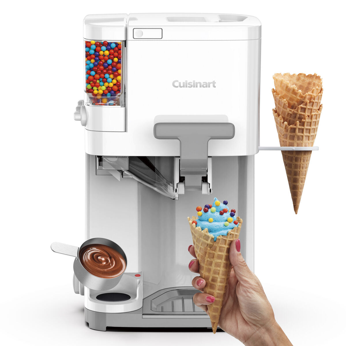 Cuisinart soft serve ice cream maker with built-in topping dispenser, shown dispensing blue ice cream into a waffle cone topped with rainbow candies.