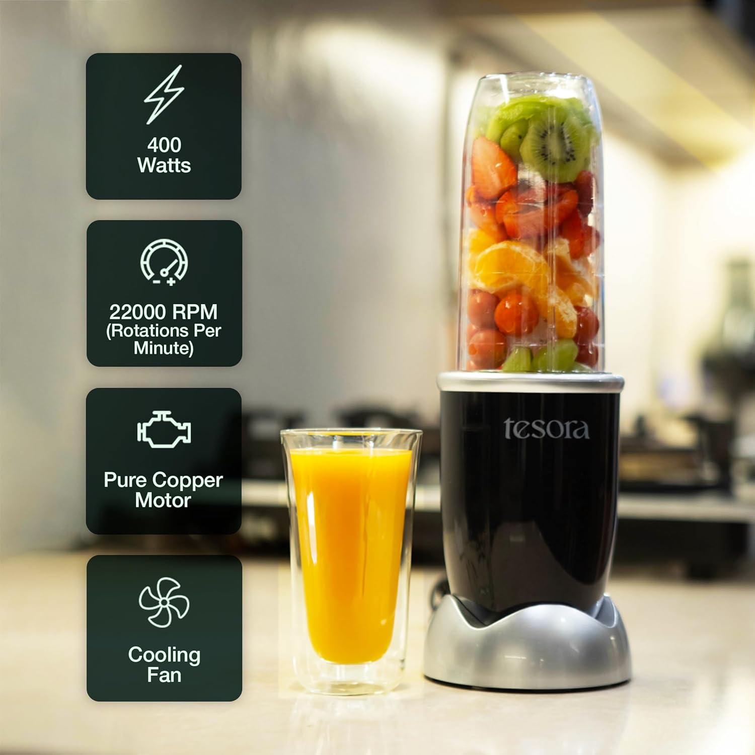 Tesora blender in a sleek black design, showcasing its powerful features like 400 watts of energy, 22,000 RPM speed, pure copper motor for durability, and an integrated cooling fan. The blender is pictured blending a vibrant mix of fruits with a glass of fresh orange juice beside it, emphasizing performance and freshness.