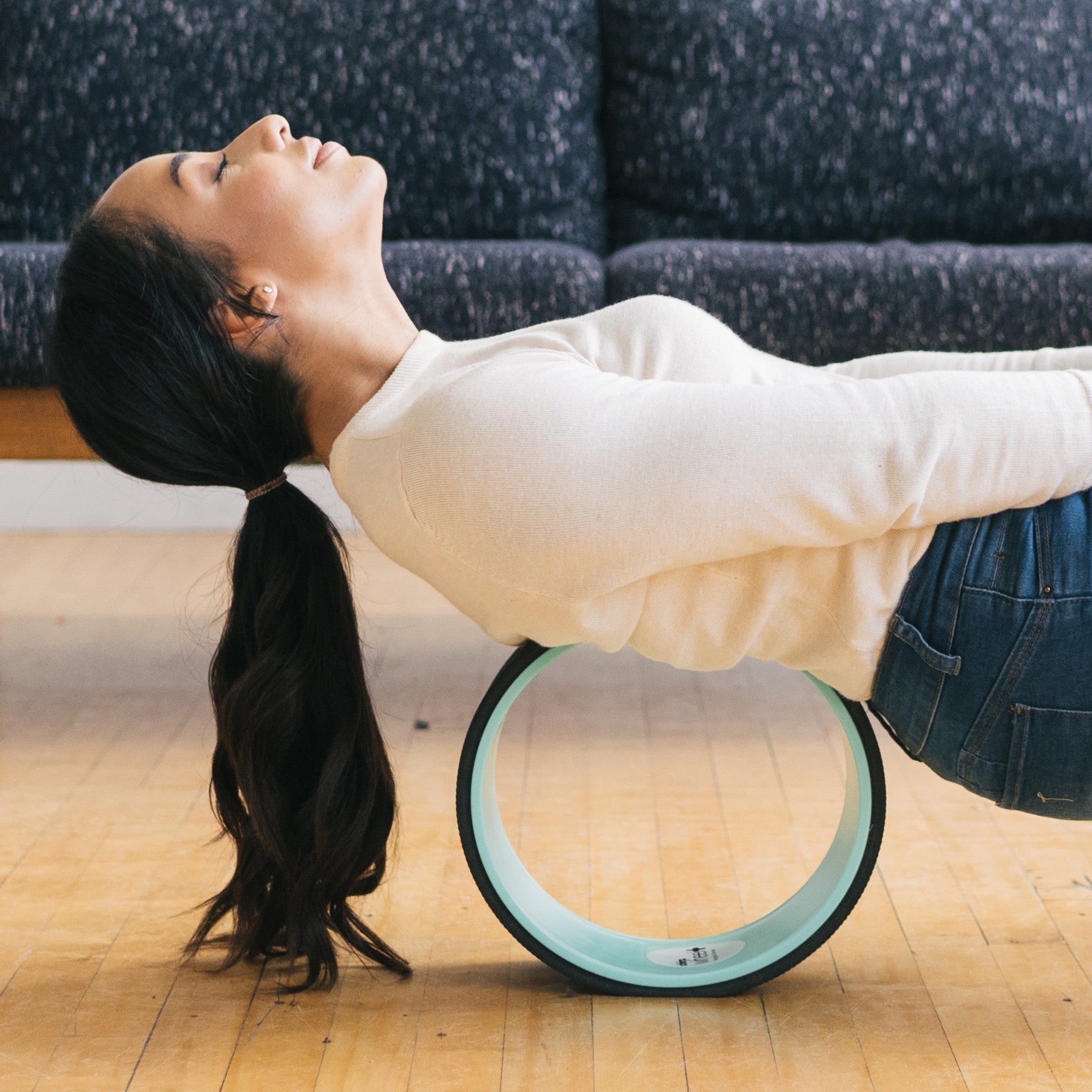 Person rolling their upper back on a Chirp Wheel+ back massage wheel