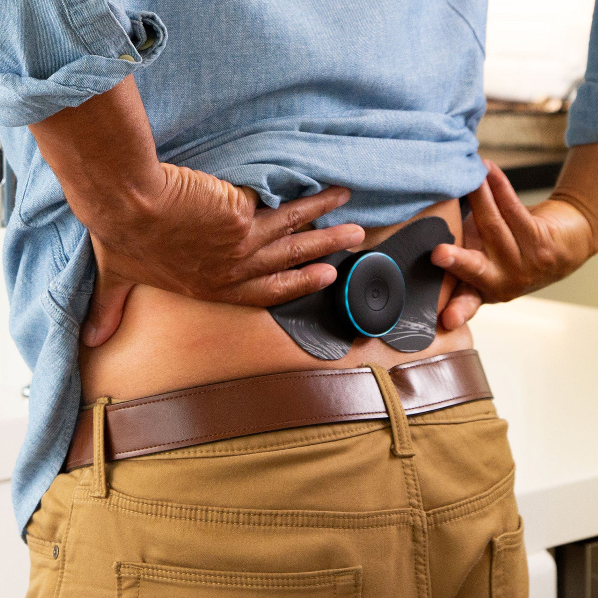 Chirp Halo pods placed on the lower back for TENS therapy