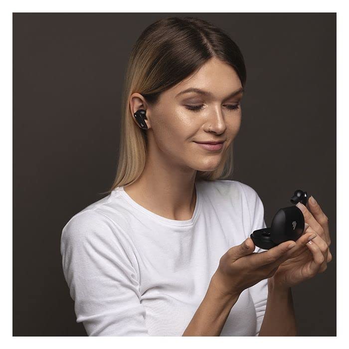 This image shows a woman wearing sleek black wireless earbuds. She is holding an open charging case in her hand, smiling softly, emphasizing the earbuds' comfortable fit and portability.