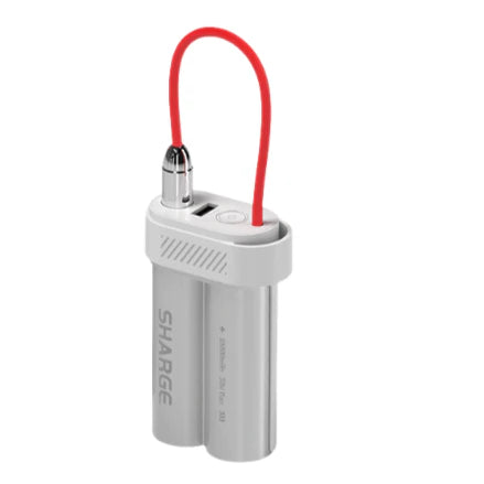 A SHARGE portable power bank designed in the shape of dual cylindrical batteries with a sleek metallic silver finish. It features a compact and modern design with a red flexible charging cable looped around the top. The power bank includes a USB port, a power button, and vented sides for heat dissipation. Ideal for convenient on-the-go charging.