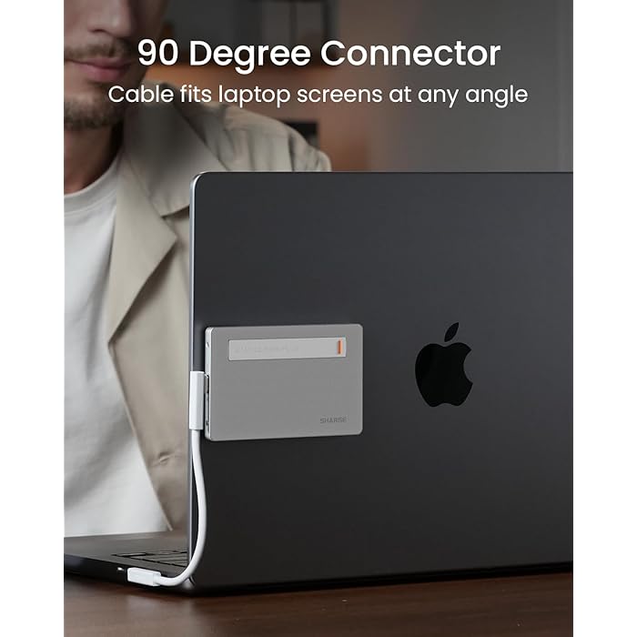 A SHARGE power bank attached to the back of a laptop with a 90-degree connector cable, designed to fit laptop screens at any angle. The image emphasizes the practicality and ergonomic design of the power bank for seamless integration with laptops.