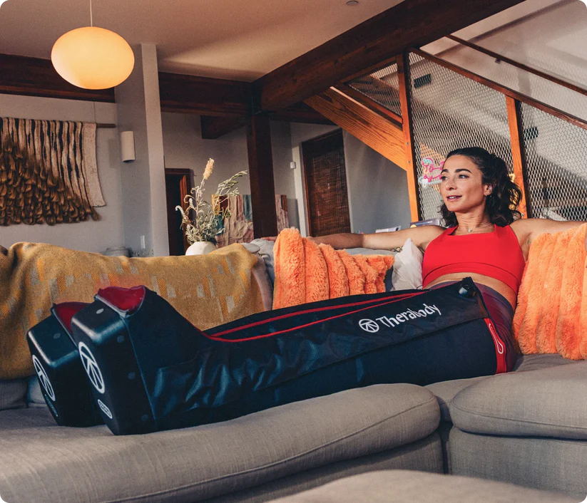 Relaxing at home in Therabody JetBoots PRO Plus